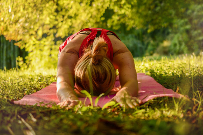 women practicing yoga outside