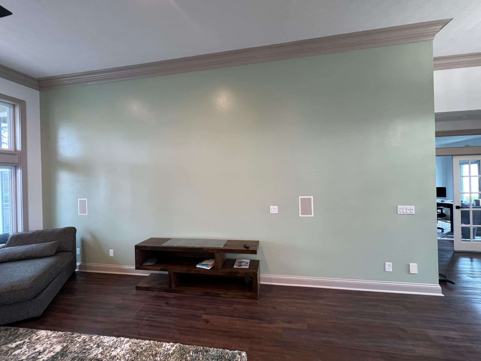 Living room remodel with new paint, trim, and flooring installation