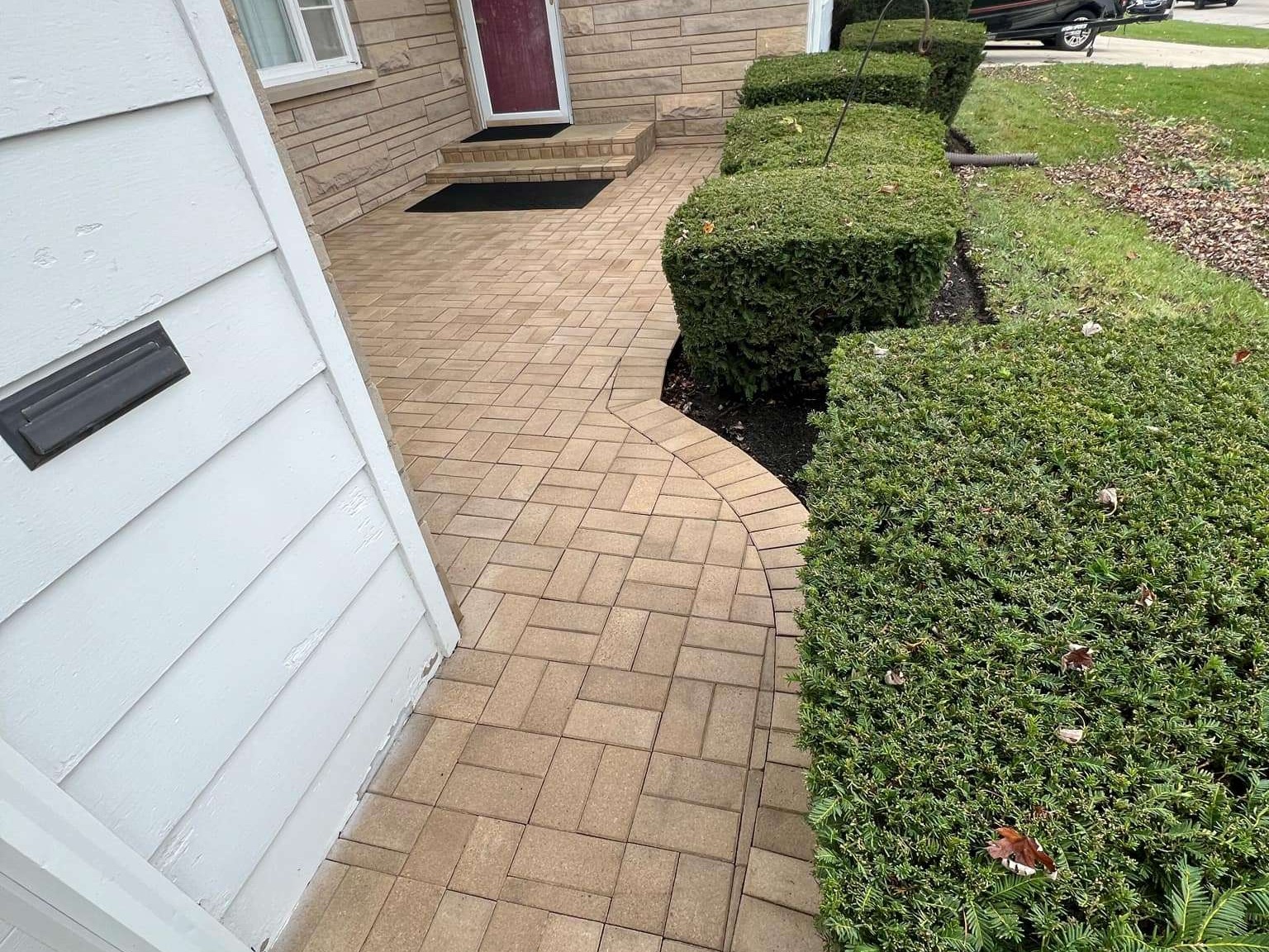 Power washed walkway and cleaned landscaping near front entry