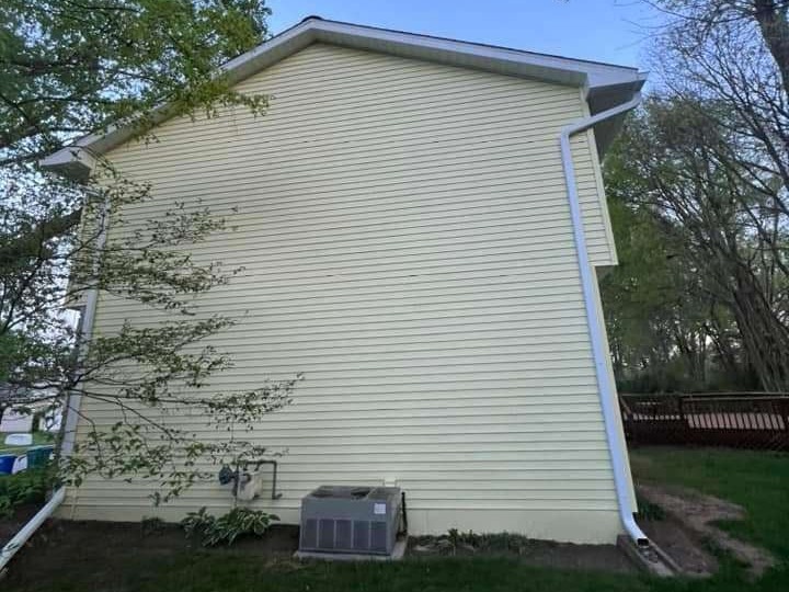 Side of home after exterior power washing service in Indiana