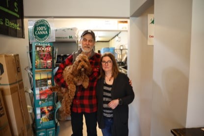 Chris holding Miley & Jackie standing in the store.