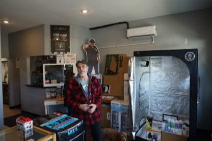 Chris standing in the front area of the store.