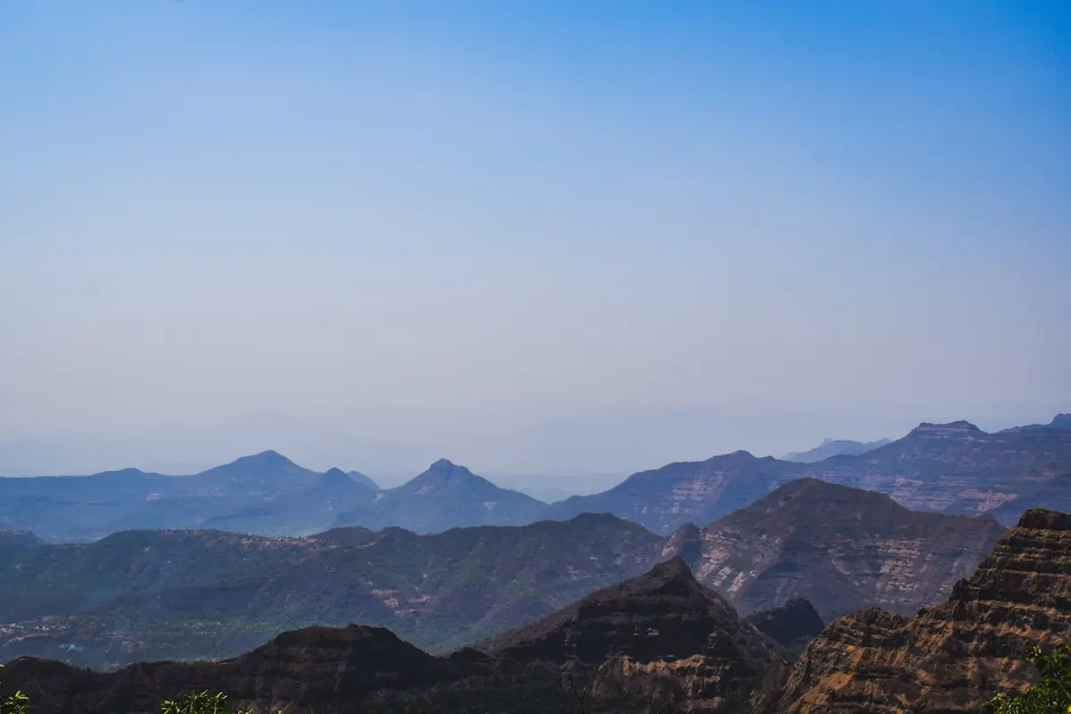 "Serene landscape of Mahabaleshwar with dense forests and rolling hills, offering a glimpse of the area's natural beauty and tranquility.