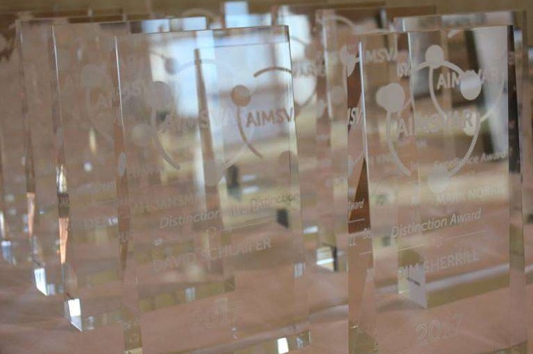 A table with glass AIMSVAR awards.